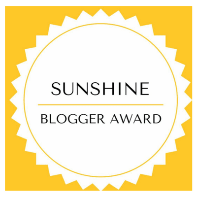 The Sunshine Blogger Award logo.